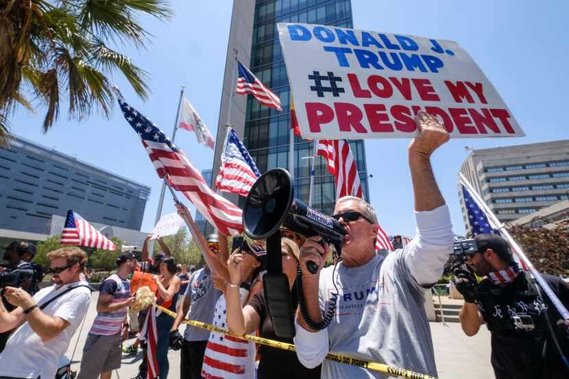 Trump supporters face counter protests during the Impeachment March to call for Congress to...