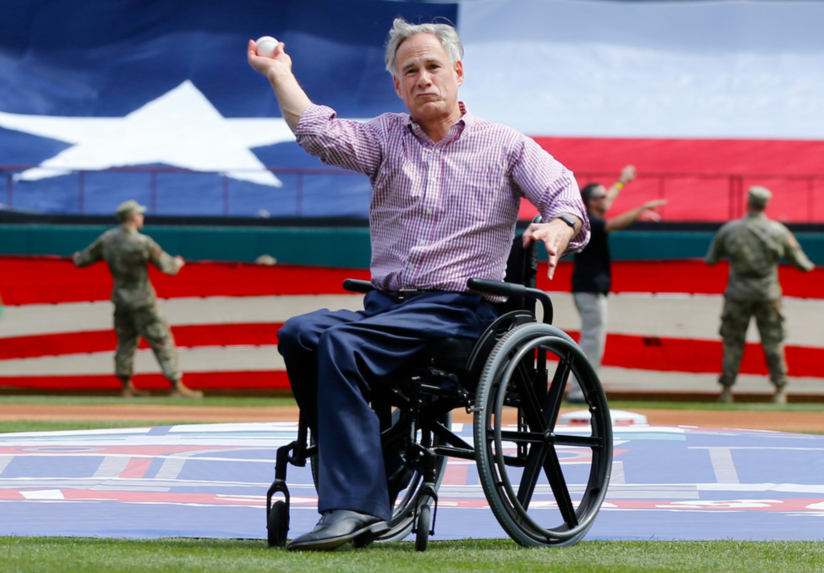 Texas governor Greg Abbott throws the ceremonial first pitch to former Arlington mayor...