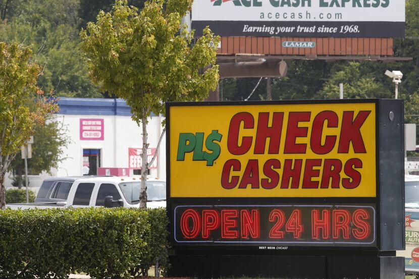 Ace Cash Express billboard looms in the background where many payday loans stores are...