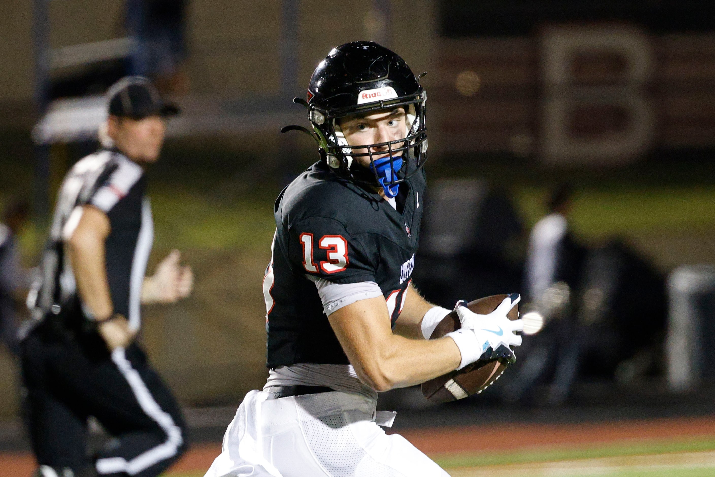 Coppell's Harry Hassmann (13) runs for a touchdown in the first half of a high school...