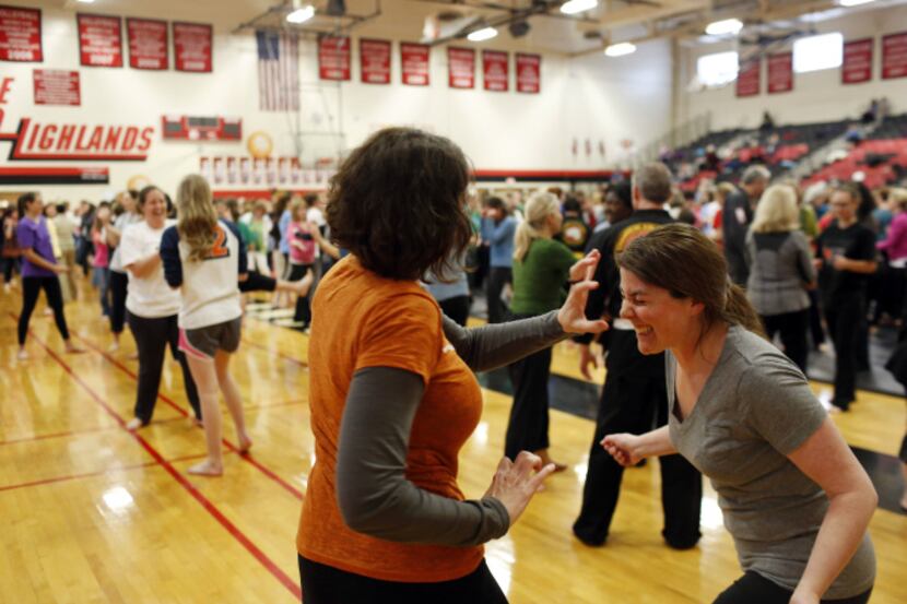 Kamy Orear (left) and Katie May practice self-defense techniques during a free class at Lake...