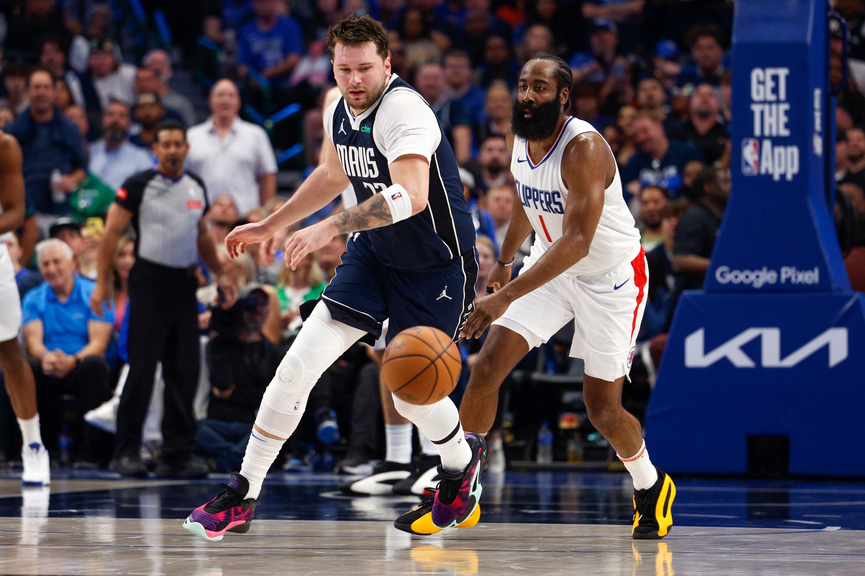 Dallas Mavericks guard Luka Doncic (77) collects a loose ball as LA Clippers guard James...