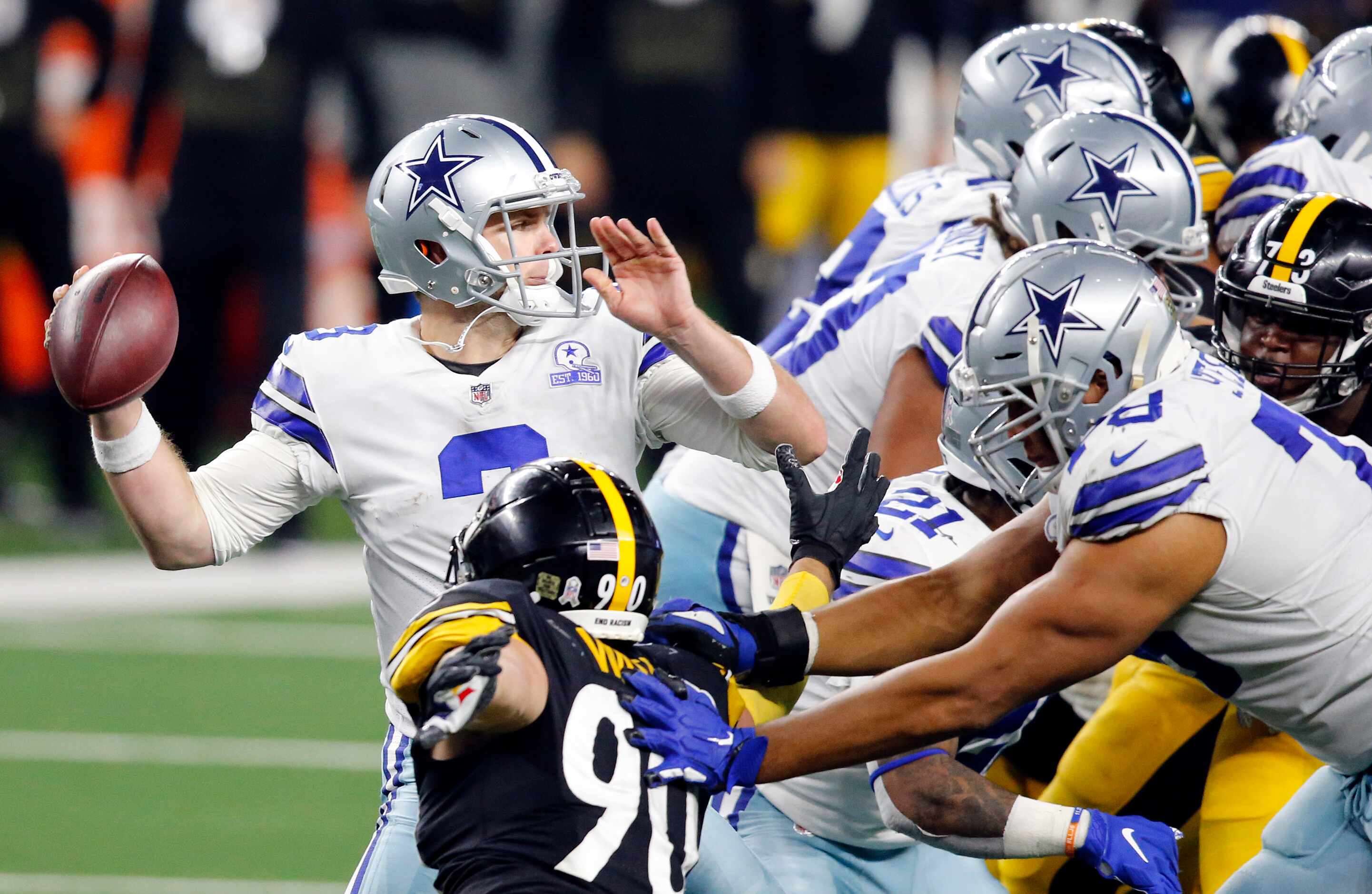 Dallas Cowboys quarterback Garrett Gilbert (3) throws from the pocket as he gets blocking...