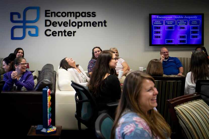 Encompass Home Health and Hospice employees laugh while playing a game of "Encompass...
