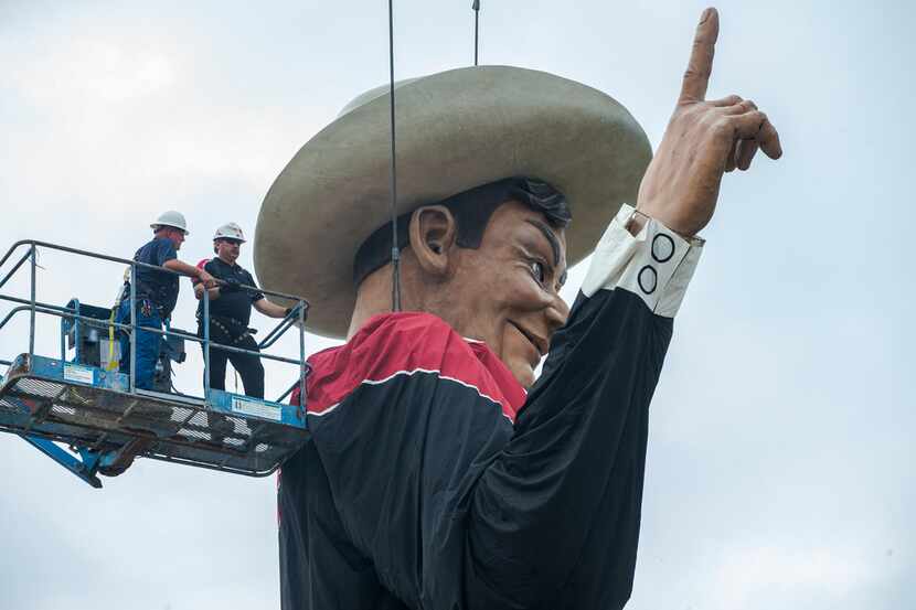 Workers help Big Tex take his spot on Friday, September 21, 2018 at Fair Park in Dallas. Big...