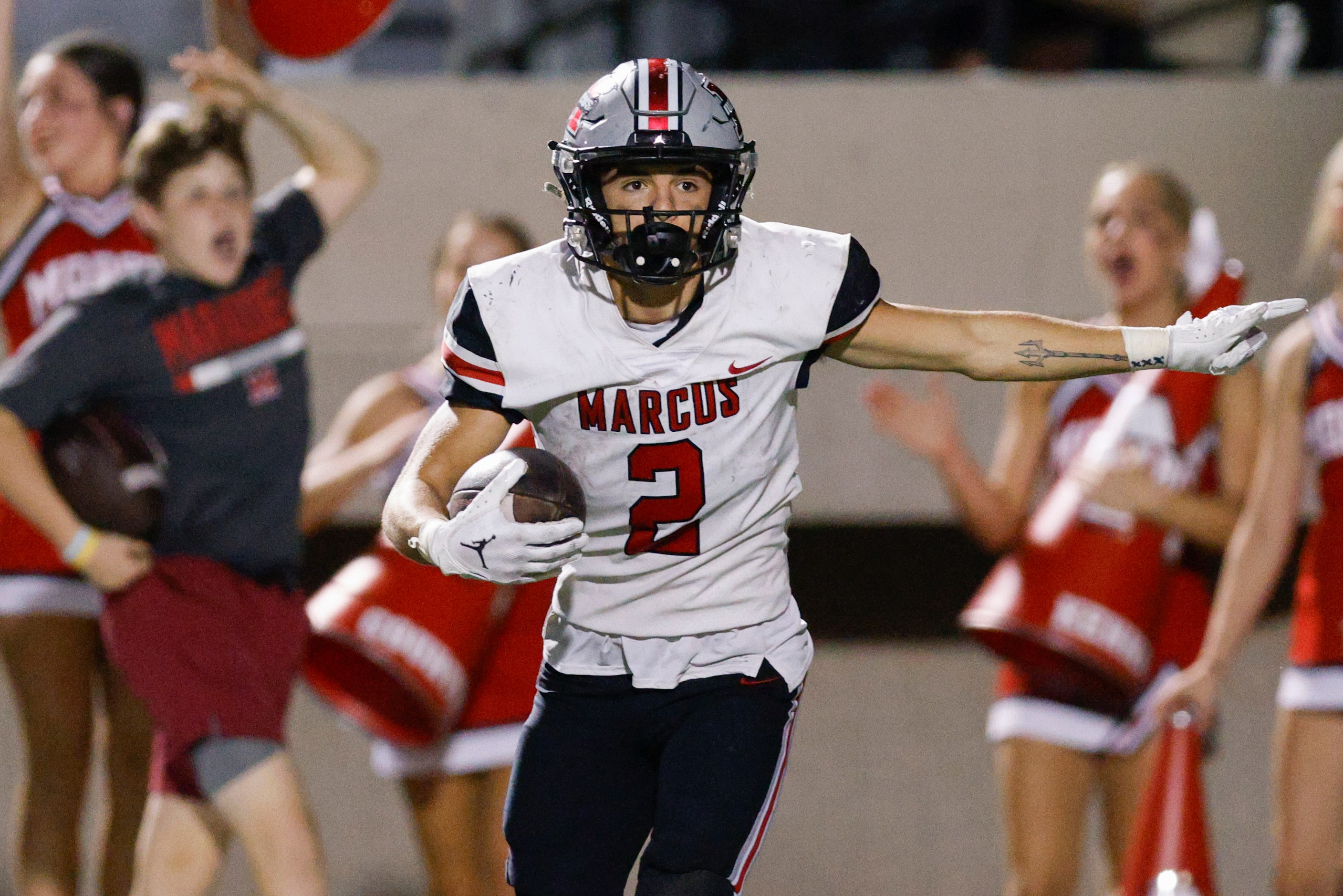 Flower Mound Marcus wide receiver Karic Grennan (2) signals a first down after making a...