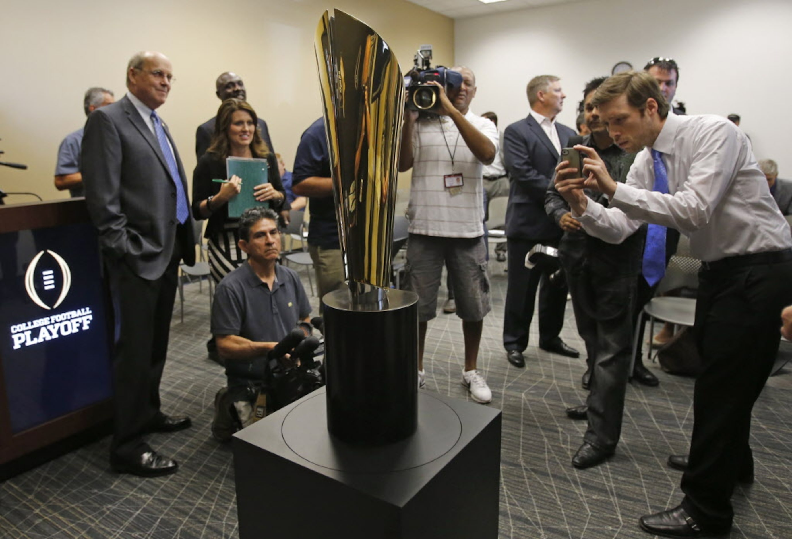 The new national championship trophy for the College Football Playoff is unveiled at a press...