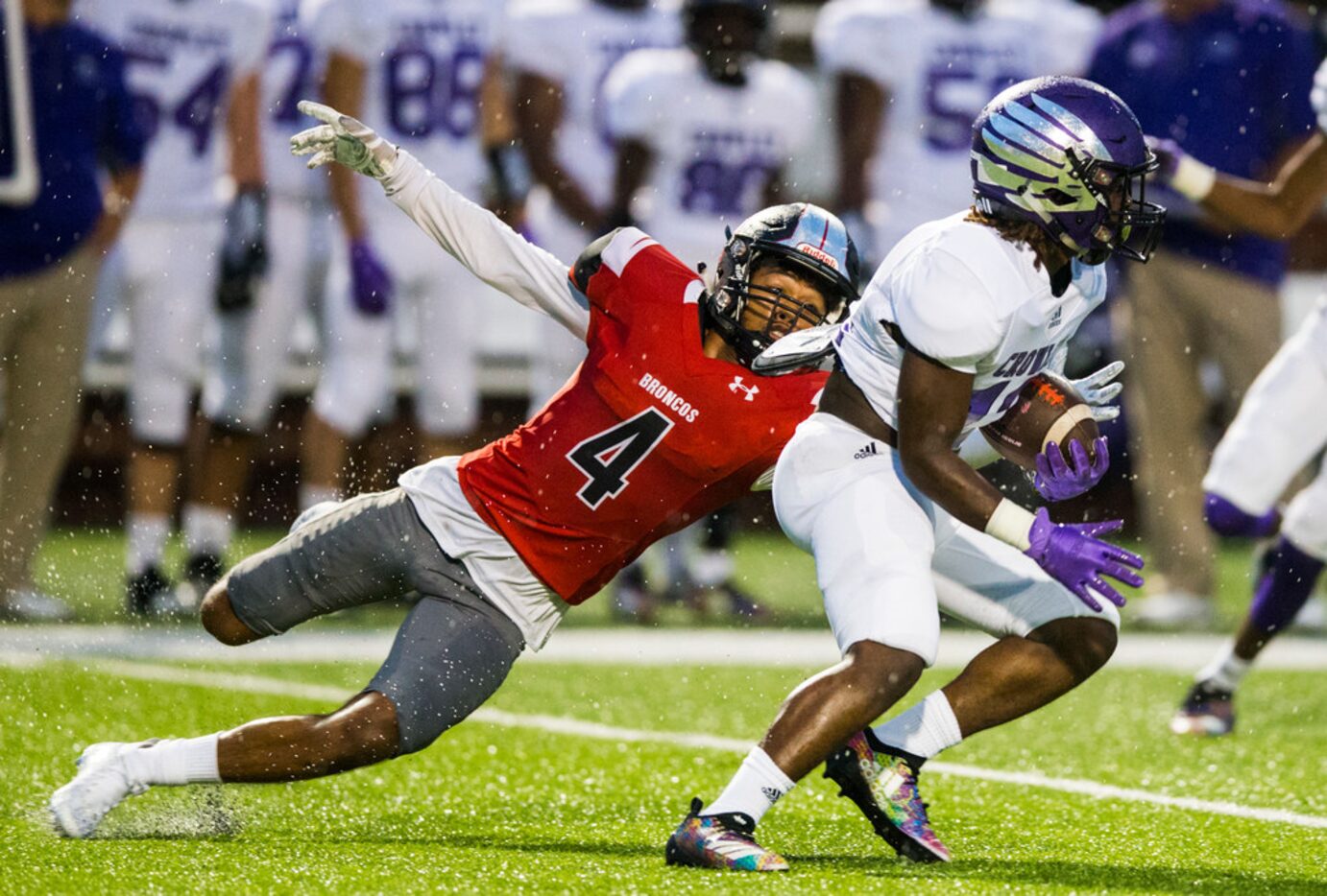 Mansfield Legacy defensive back Jadyn Ishmael (4) tackles Crowley's Dewayne Bradley (12)...