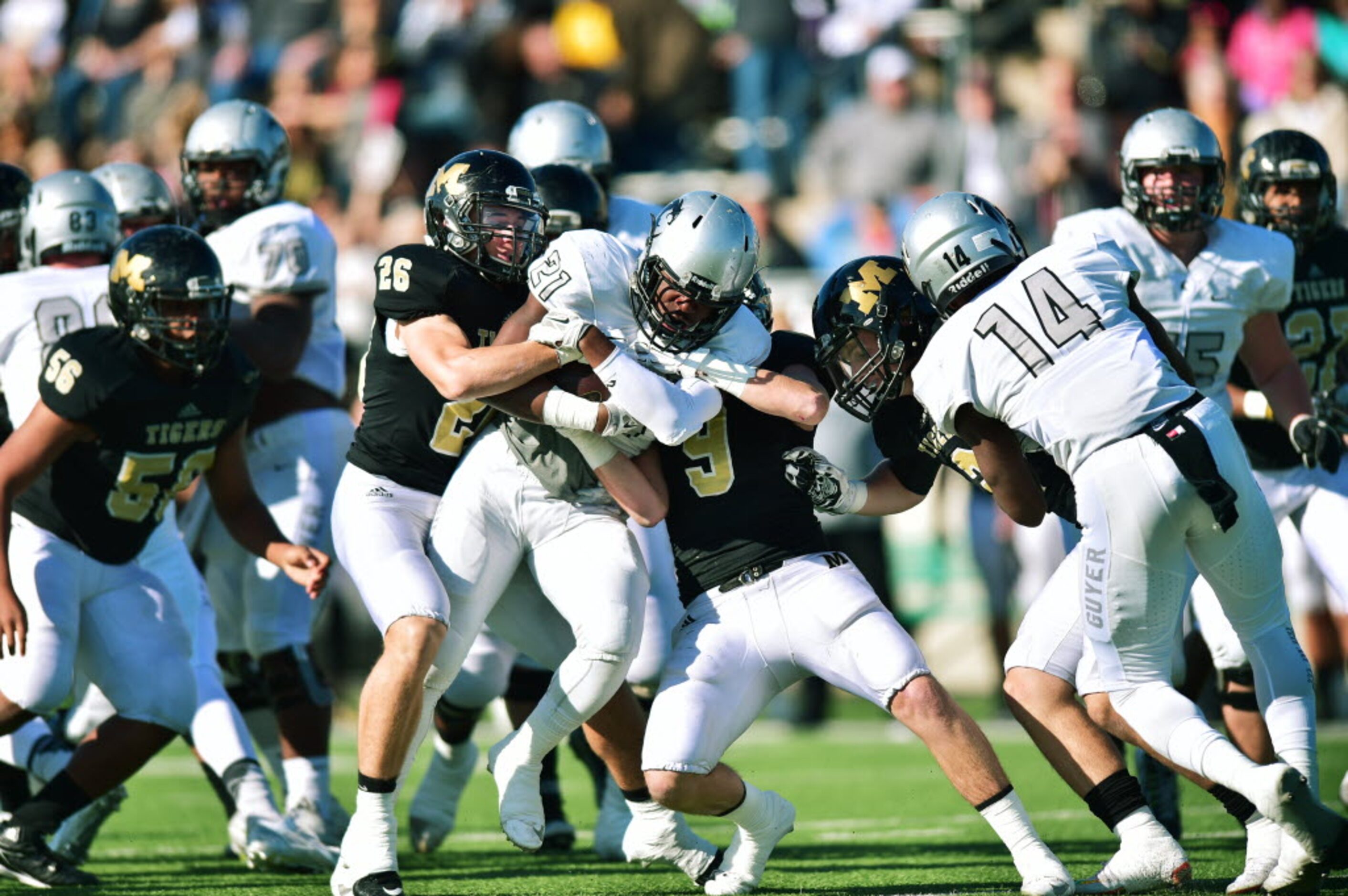 Guyer junior running back Christian Moore (21) stays on his feet fighting for extra yards...