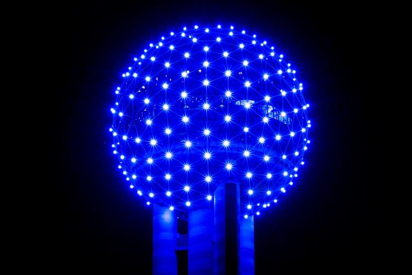 Reunion Tower glows blue as the downtown Dallas skyline lights up in blue in recognition of...