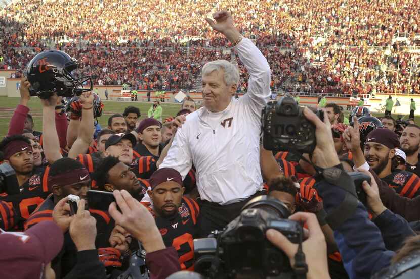 Virginia Tech head coach Frank Beamer is carried off the field by his players after an NCAA...