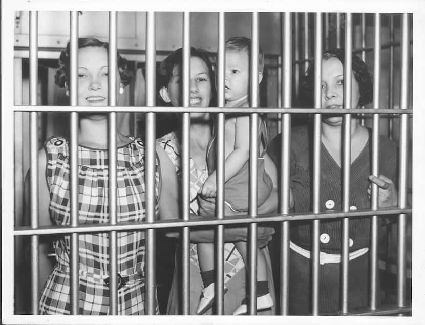 Charlotte Duncan, Jessie Burgett with son Roy, and May Sealey in the Dallas jail in 1935 for...