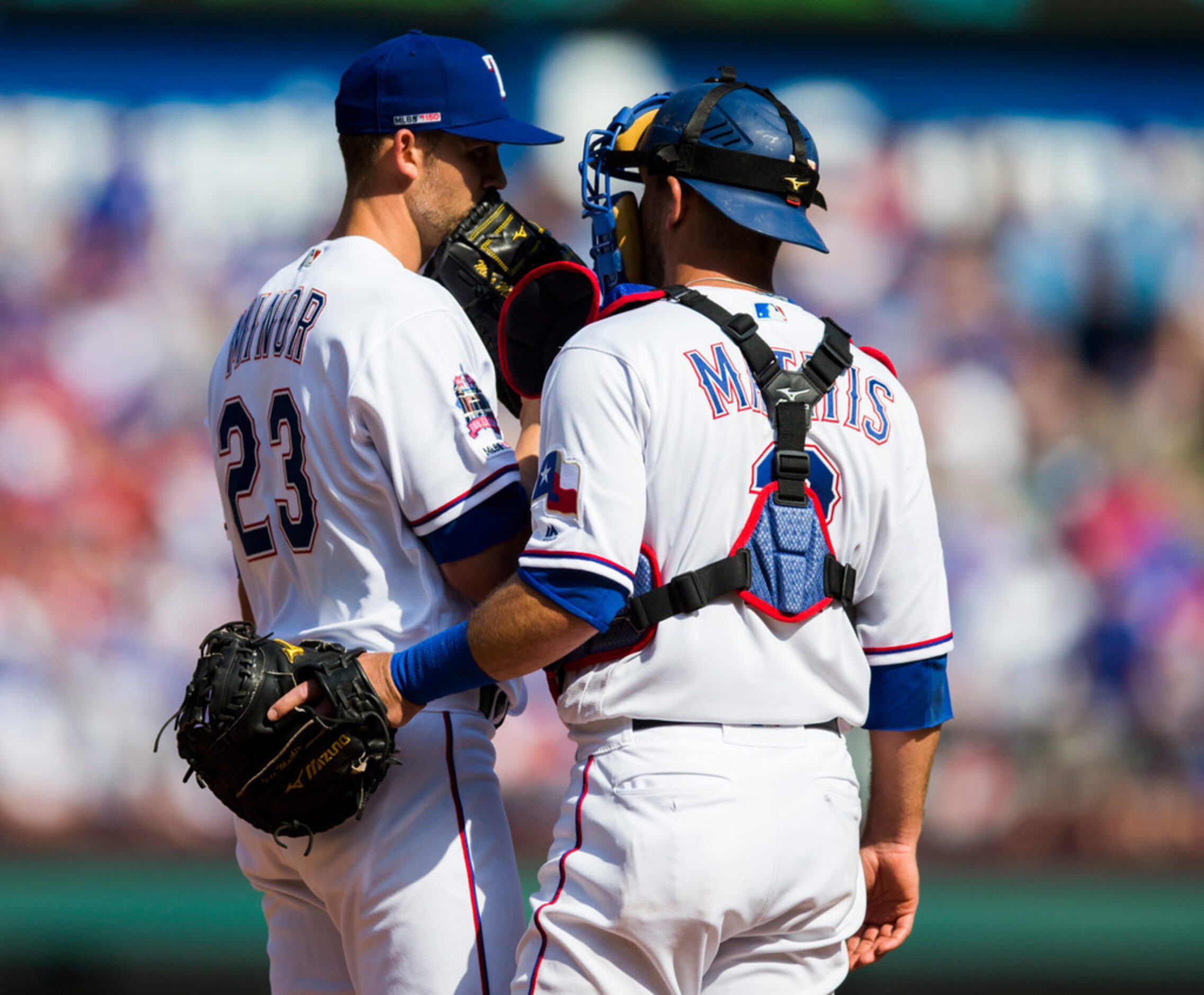 Texas Rangers starting pitcher Mike Minor (23) and catcher Jeff Mathis (2) conference on the...