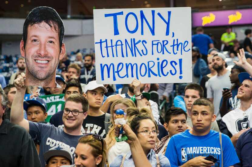 Dallas Mavericks fans and Dallas Cowboys fans hold up signs thanking former Cowboys...