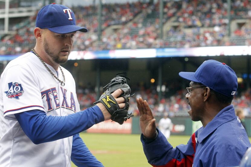 Texas Rangers starting pitcher Matt Harrison (54) is congratulated by manager Ron Washington...