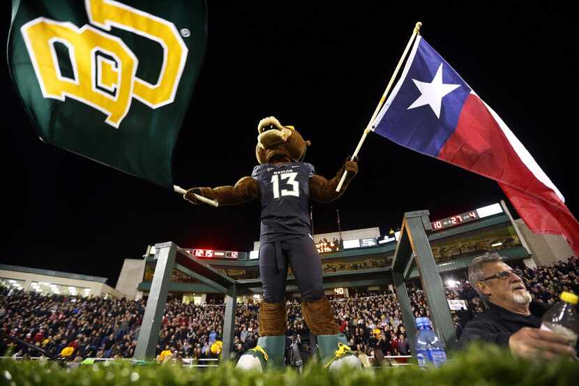 Baylor Bears mascot Bruiser waves the school and state colors during their game with the...
