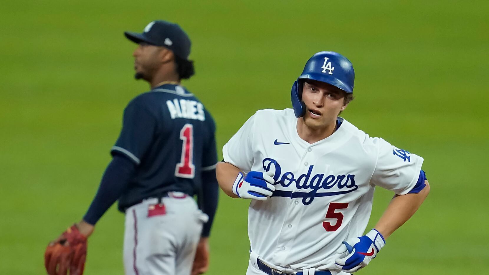 Los Angeles Dodgers shortstop Corey Seager rounds the bases past Atlanta Braves second...