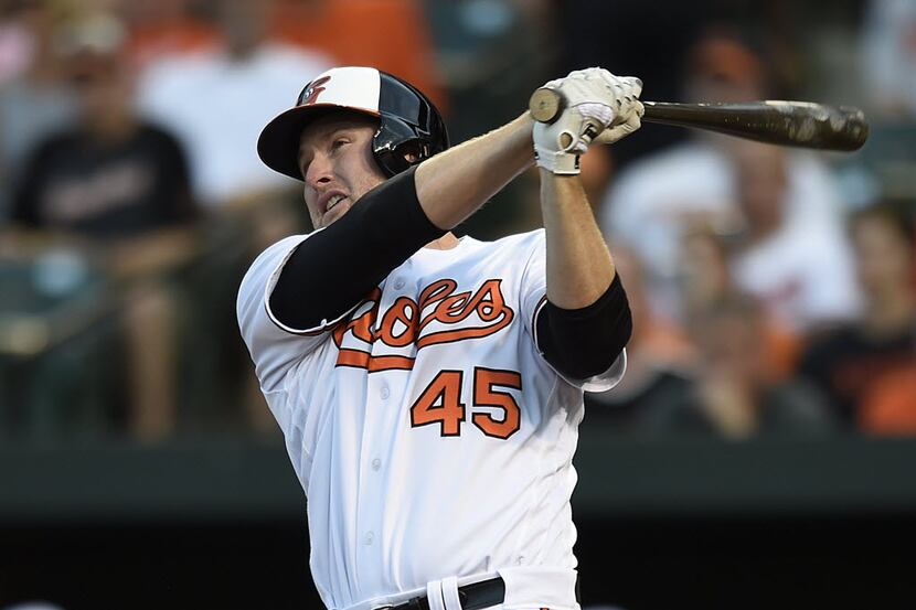 Baltimore Orioles' Mark Trumbo follows through on a three-run home run against the Houston...