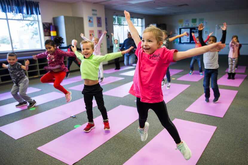 Charlotte Mayer (right) and other kindergarten students participated in a yoga class Jan. 24...