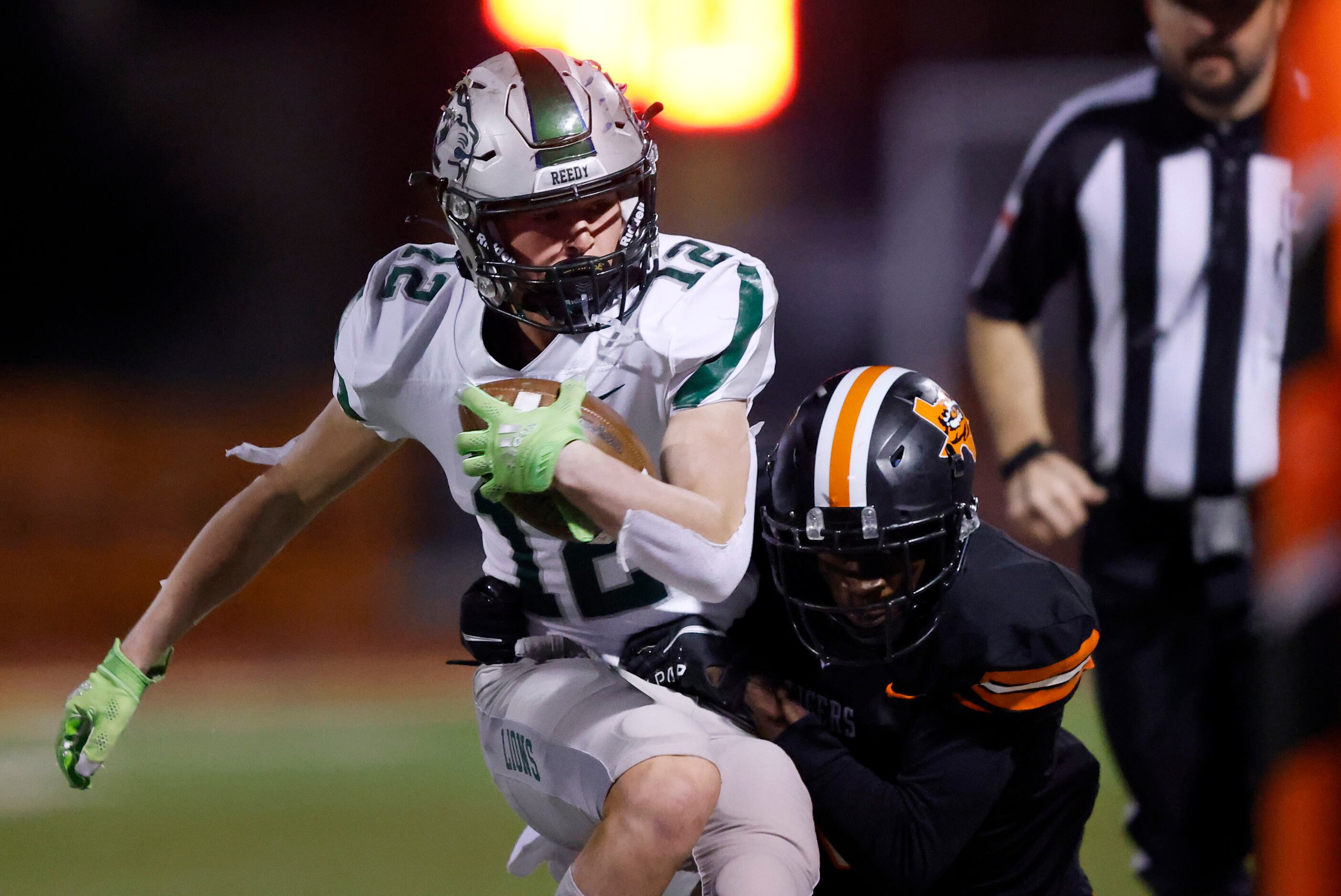 Frisco Reedy wide receiver Erik Barr (12) is tackled near the sideline by a Lancaster...