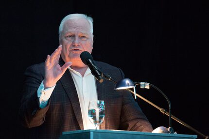 Master of Ceremonies, Dale Hansen, speaks at the Dallas ISD Hall of Fame induction ceremony...