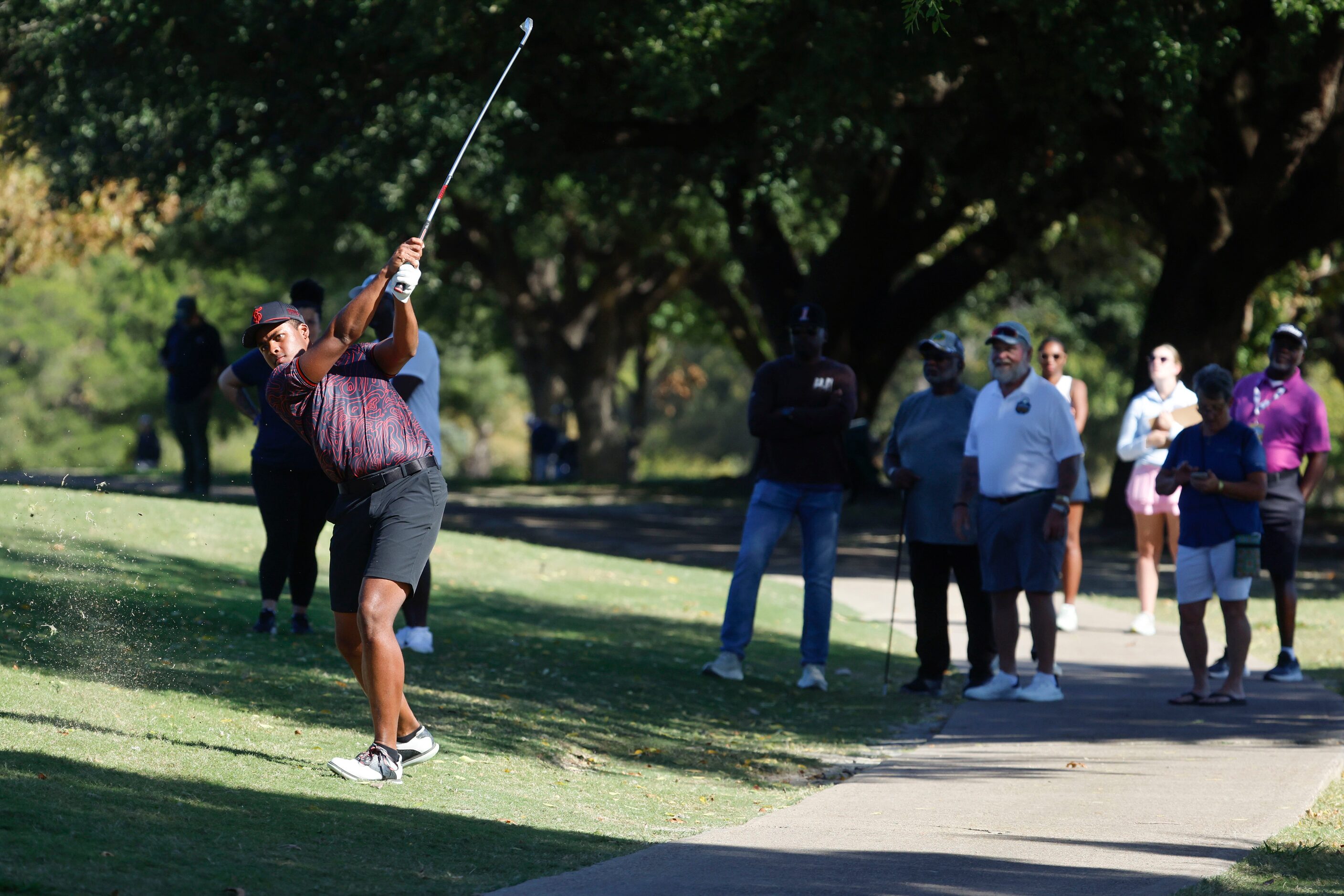 Crowd watch as Kci Lindskog of Texas Southern University  hits into the fifth fairway during...