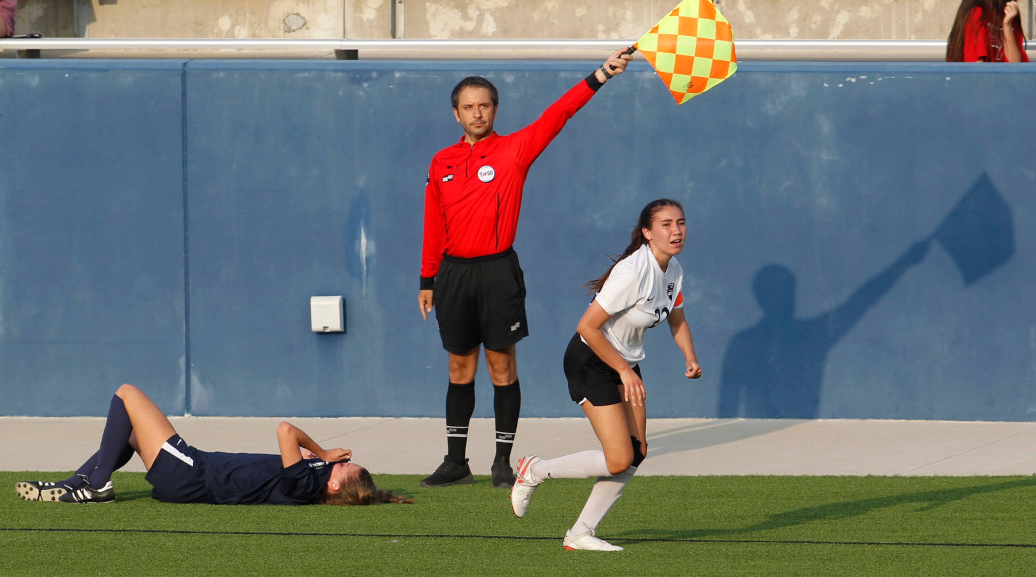 A game official awards ball possession to Flower Mound as Lady Jaguars' Hallie Augustine (6)...