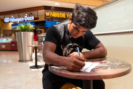 Alonzo Flores, 19, completes a job application for Nestle Toll House Cookies at Galleria...