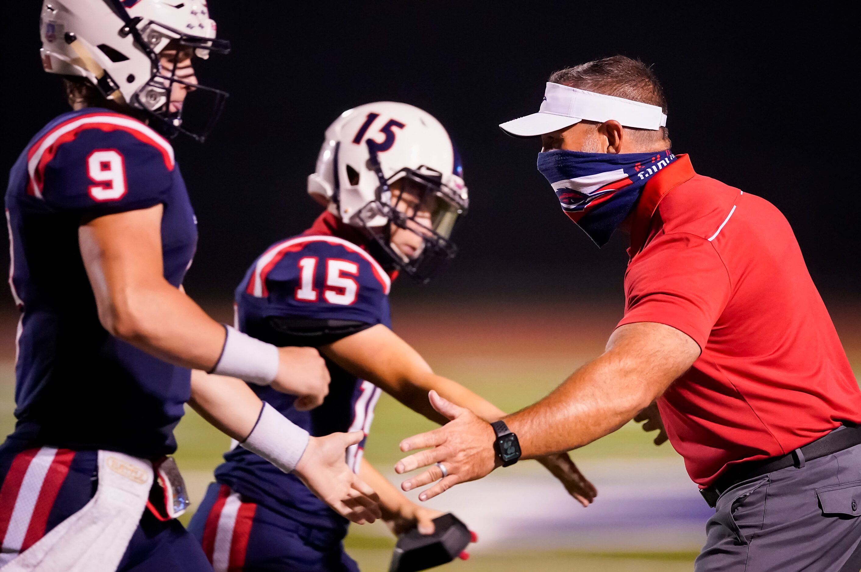 Aubrey head coach Keith Ivy celebrates a score with his players during the second half of a...