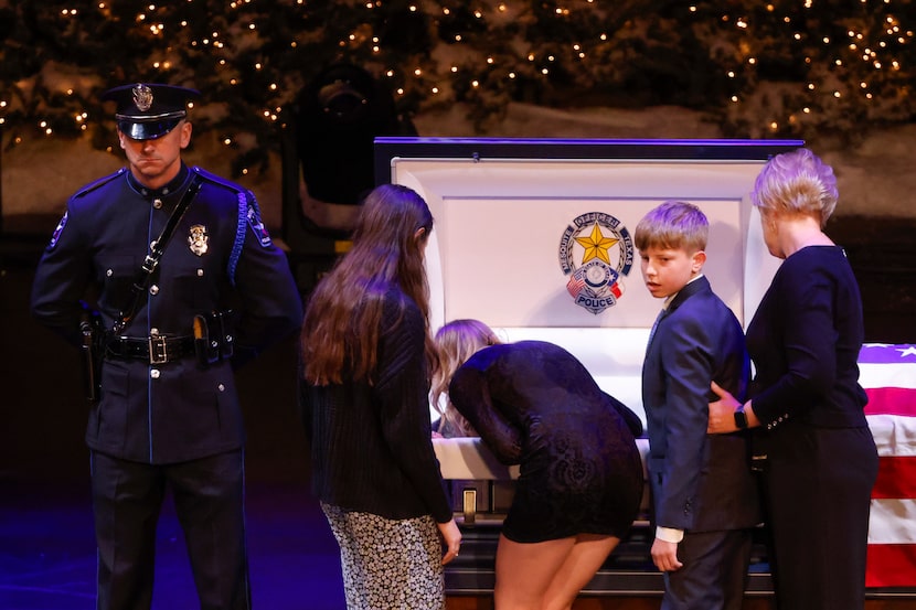 Shelby Houston, daughter of slain Mesquite police officer Richard Houston II, kisses her...