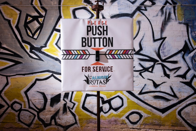 A bell is used outside of the drive-through service at Las Almas Rotas in Dallas, July 18,...