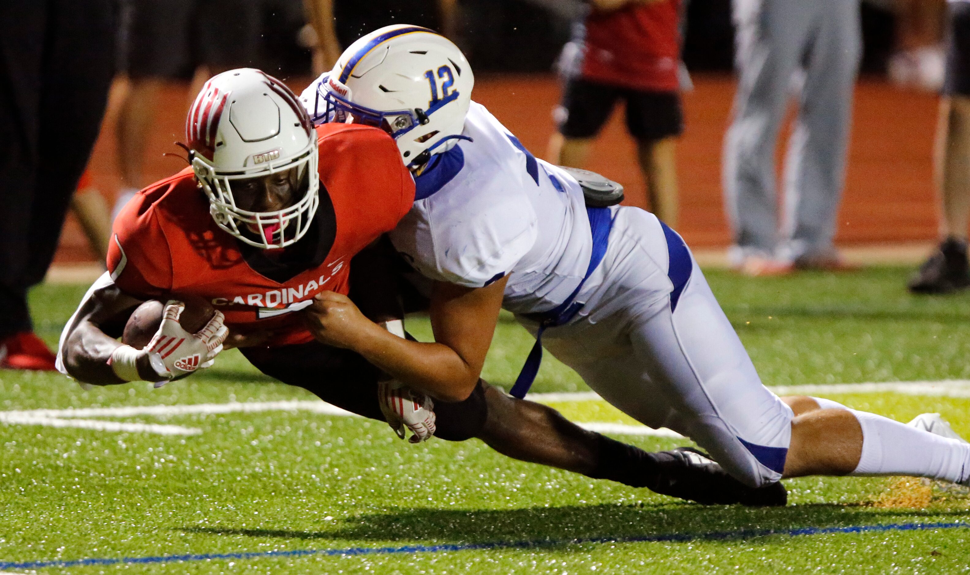 Melissa High School wide receiver Chanse Holiday (7) is brought down by Sunnyvale High...