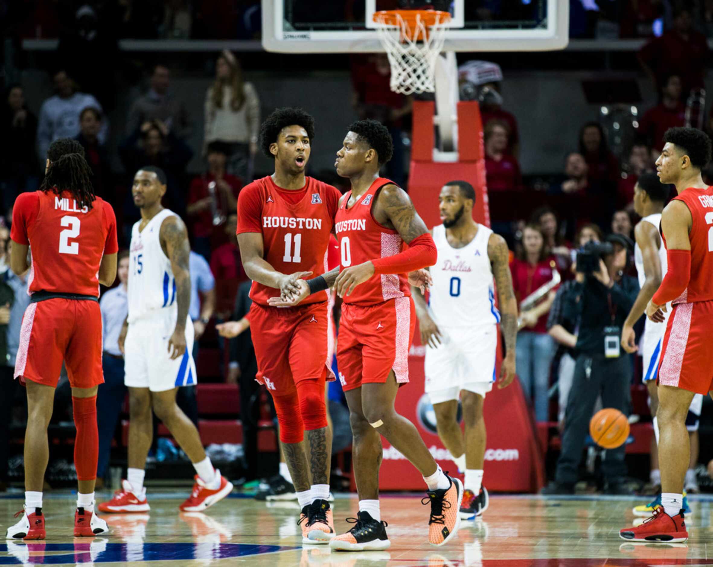 Houston Cougars guard Nate Hinton (11) celebrates with guard Marcus Sasser (0) after Sasser...