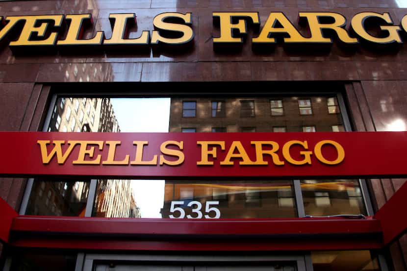 FILE - This May 6, 2012, file photo, shows a Wells Fargo sign at a branch in New York. Wells...