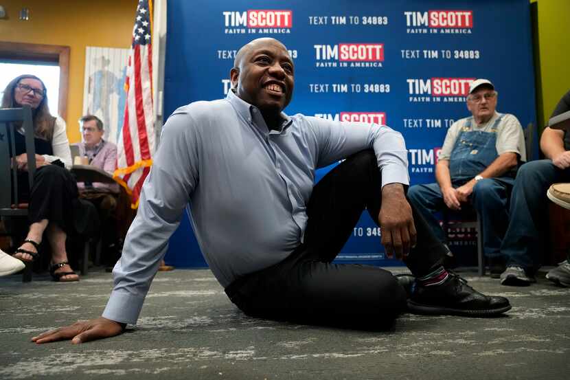 Republican presidential candidate Sen. Tim Scott, R-S.C., listens to a question from an...