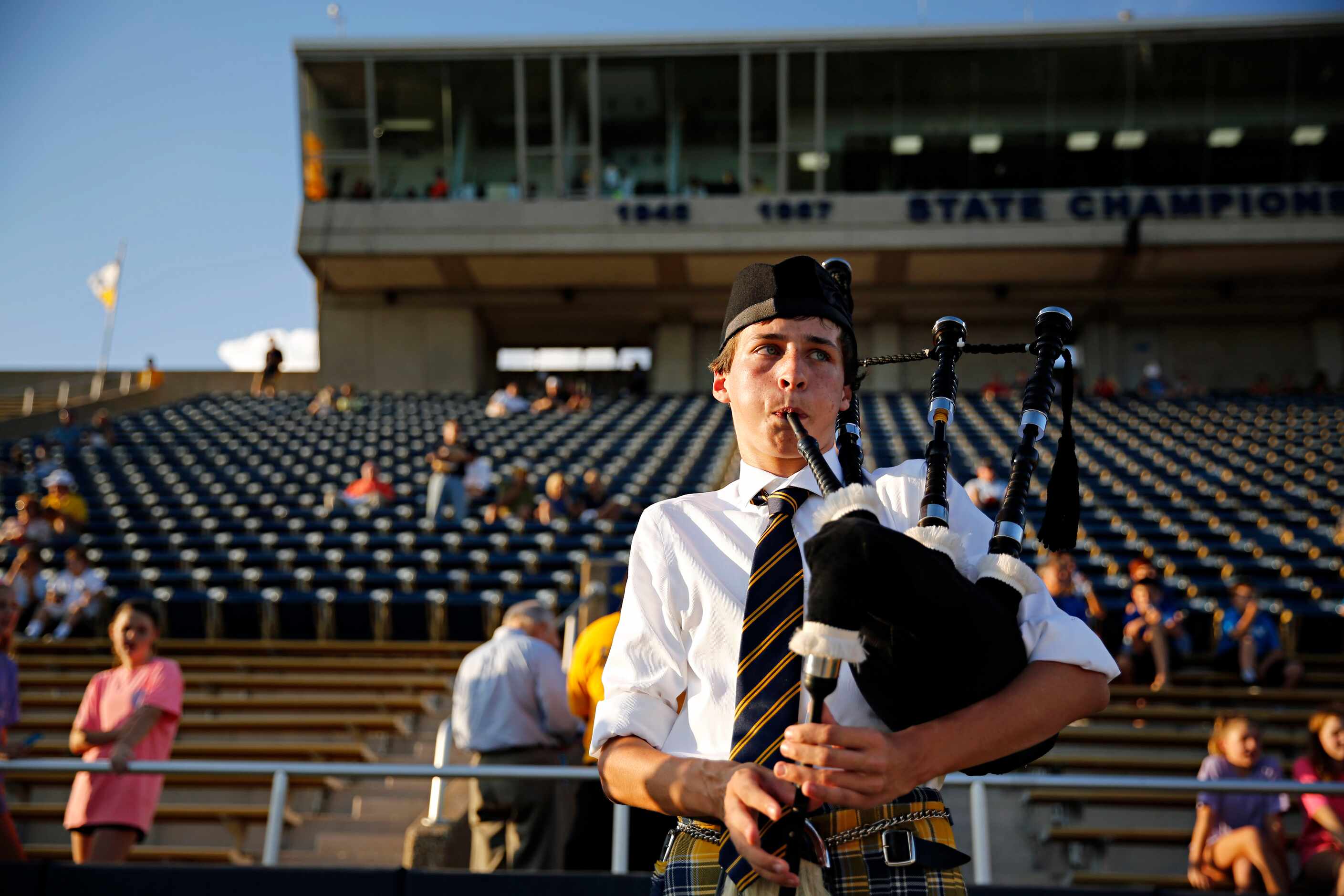 Highland Park senior Ben Smith plays bagpipes on the sideline before the Scots game against...