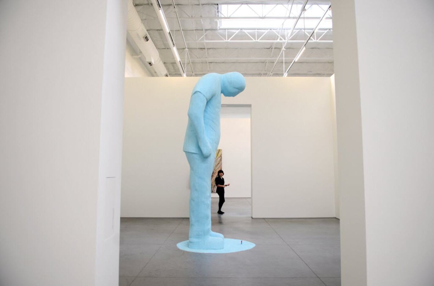Sierra Sanchez, a museum guard, looks after an untitled sculpture by Tom Friedman during a...