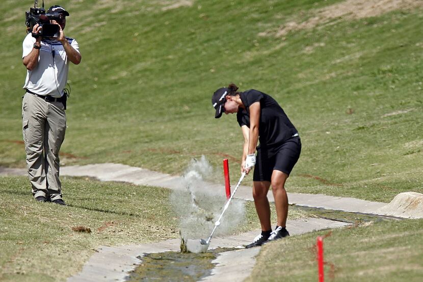 Carlota Ciganda of Spain hits from water hazard on the 12th hole, as she made a bride,...