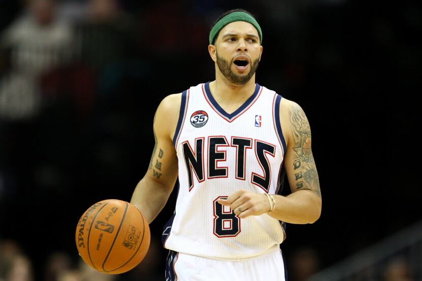 Deron Williams #8 of the New Jersey Nets brings the ball up court in the second half against...