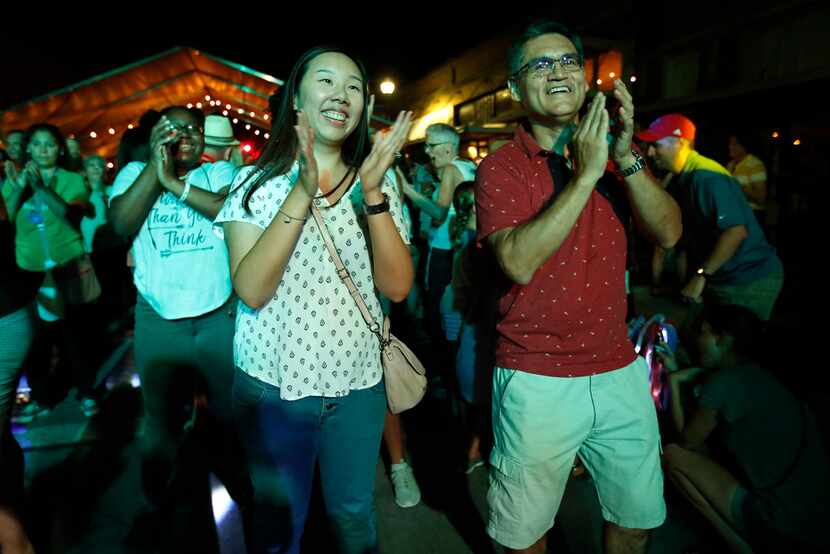 Sherry and Carlos Camacho clap as they do the chicken dance during McKinney Oktoberfest in...