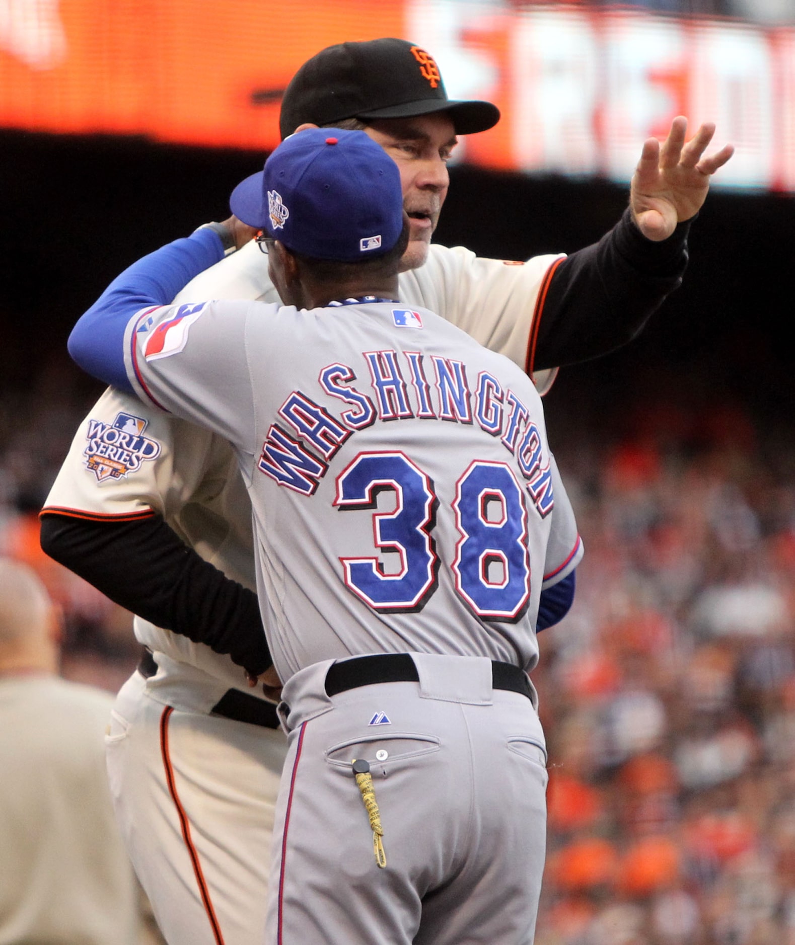 Texas Rangers manager Ron Washington talks to San Francisco Giants manager Bruce Bochy...