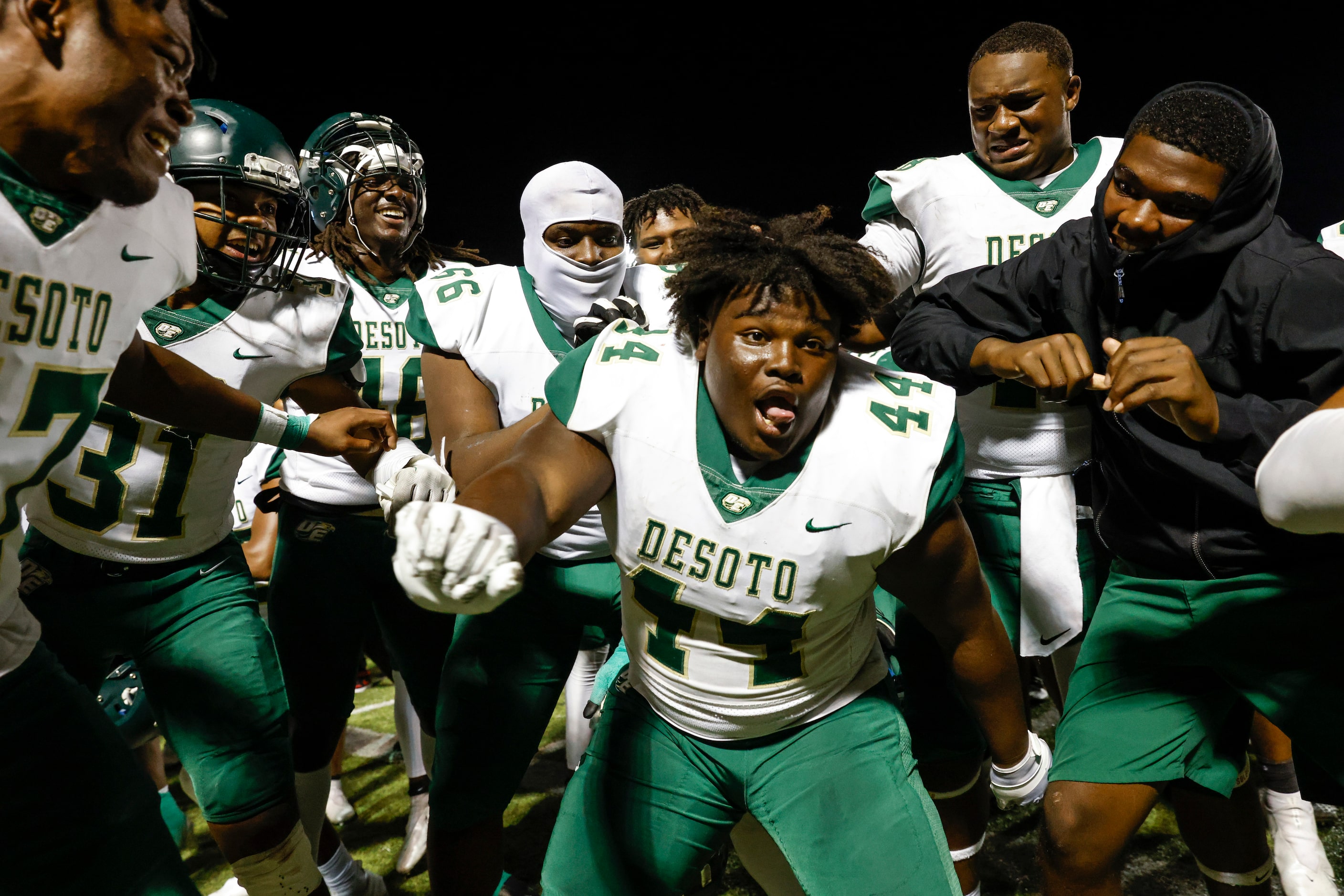 DeSoto players including Marshall Kirven (44) celebrate after winning against Lake Ridge...