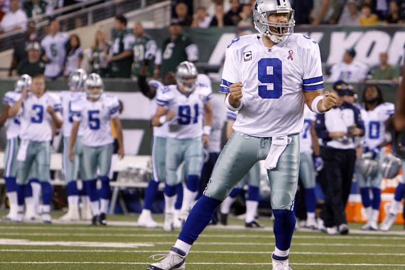 Dallas Cowboys quarterback Tony Romo (9) pumps his fist in excitement after throwing a first...
