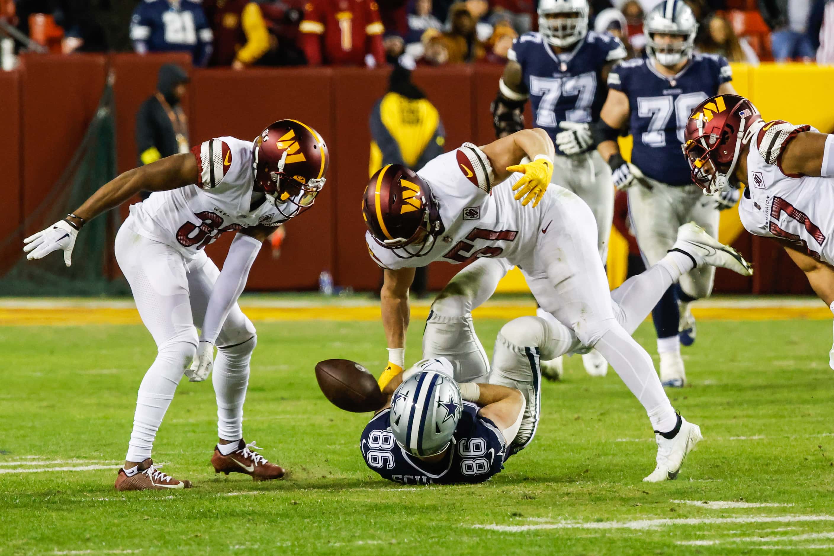 Dallas Cowboys tight end Dalton Schultz (86) loses a pass after being tackled by Washington...