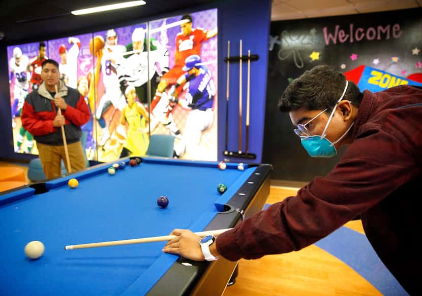 David Mojica, 14, of Duncanville (right) plays pool with his older bother Erick Padilla at...