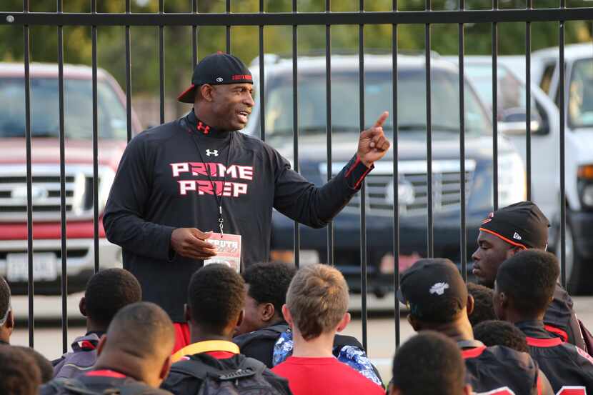 Prime Prep co-founder and coach Deion Sanders talked with his team before warmups at an...