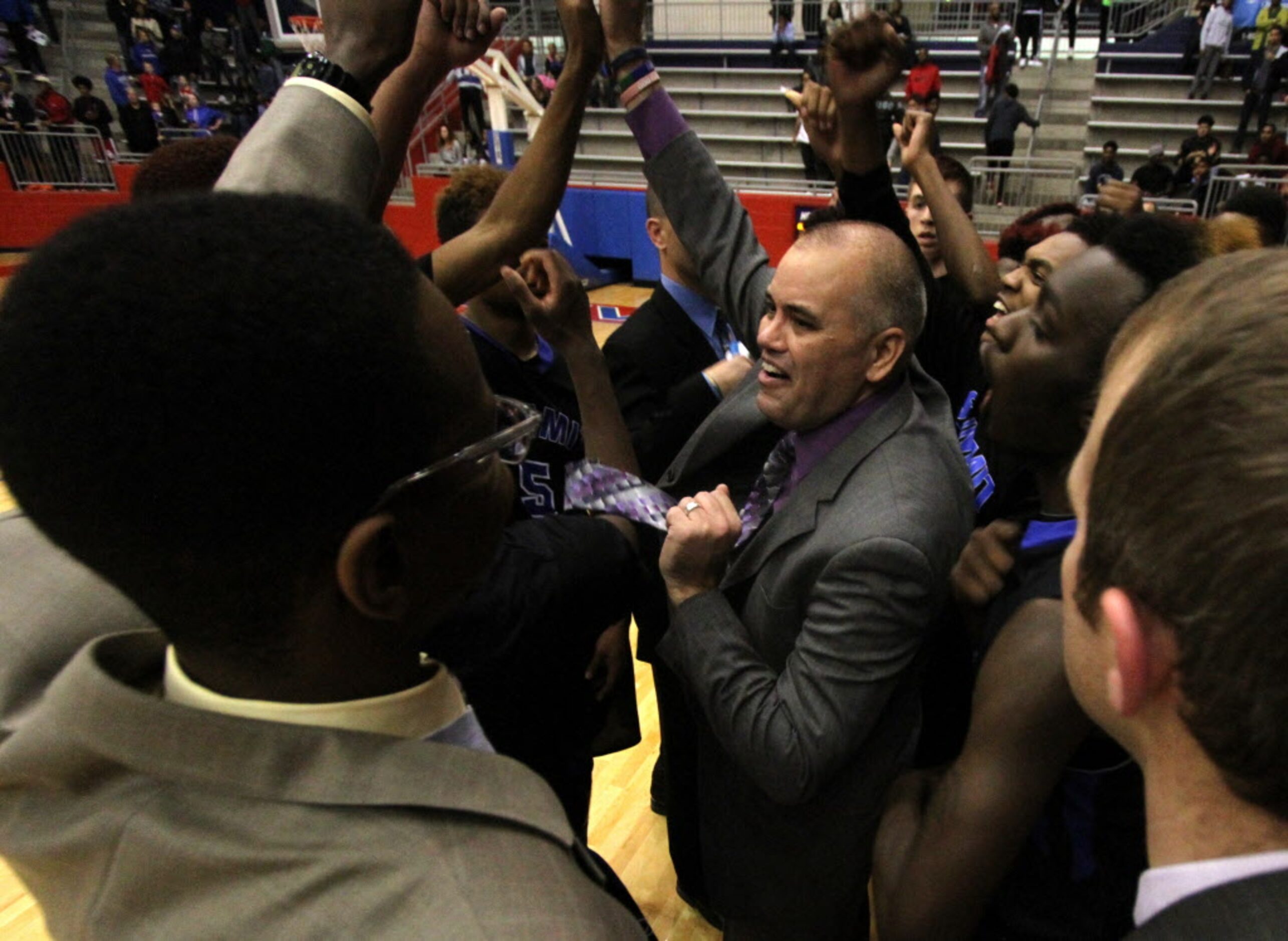 Mansfield Summit head coach Jason Mutterer shares a smile with his team during the game's...