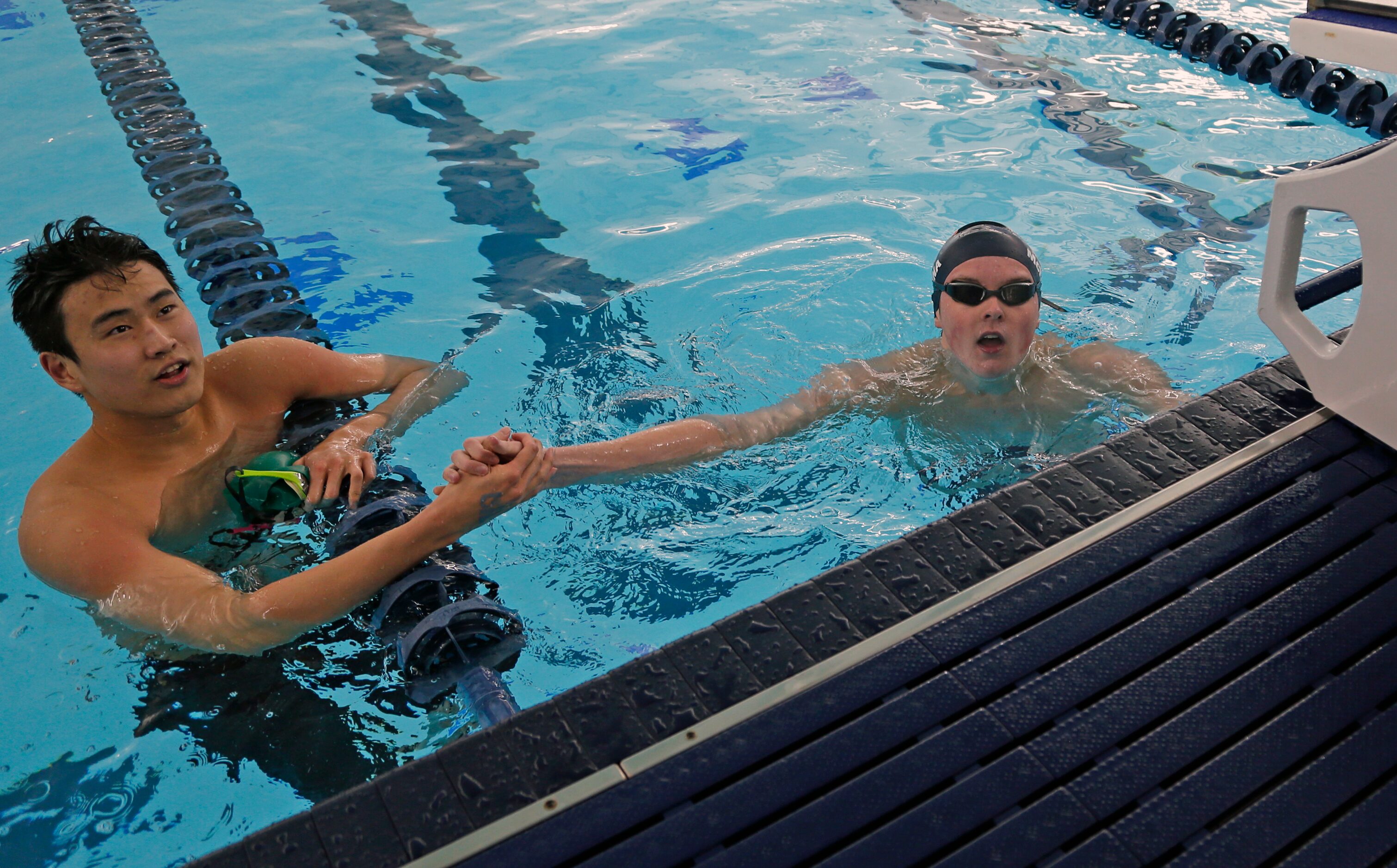 Frisco Wakeland Connor MCKenna,R, gets congratulations from Thomas Wu after winning the 100...