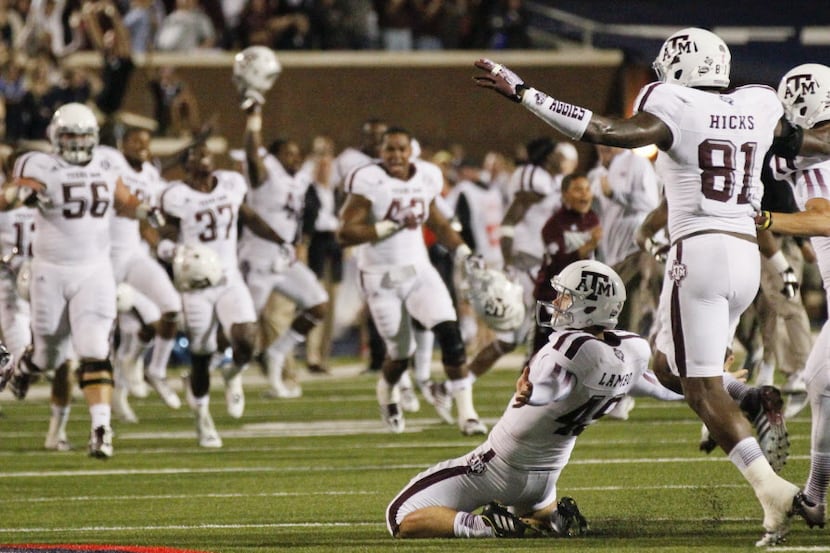 Texas A&M kicker Josh Lambo (49) slides towards his bench on his knees in a soccer style of...