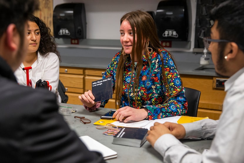 Club co-founder Janet Shuey (center) discusses the city's climate action plan during a...